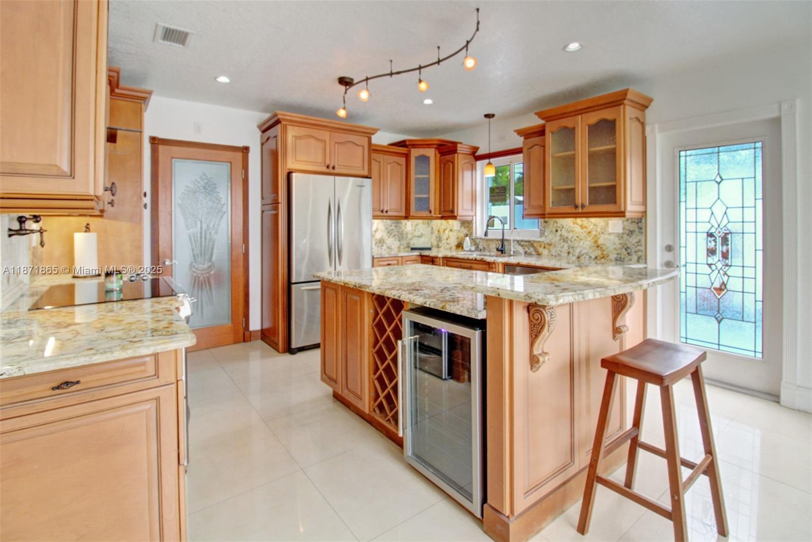 9930 Southwest 48th Street Miami, FL 33165 - Photo 13 of 29 a kitchen with stainless steel appliances granite countertop a stove and cabinets