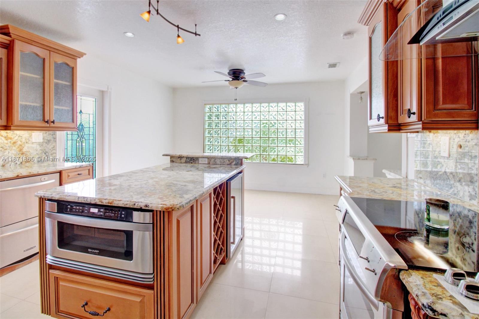 9930 Southwest 48th Street Miami, FL 33165 - Photo 14 of 29 a kitchen with stainless steel appliances granite countertop a stove and a sink