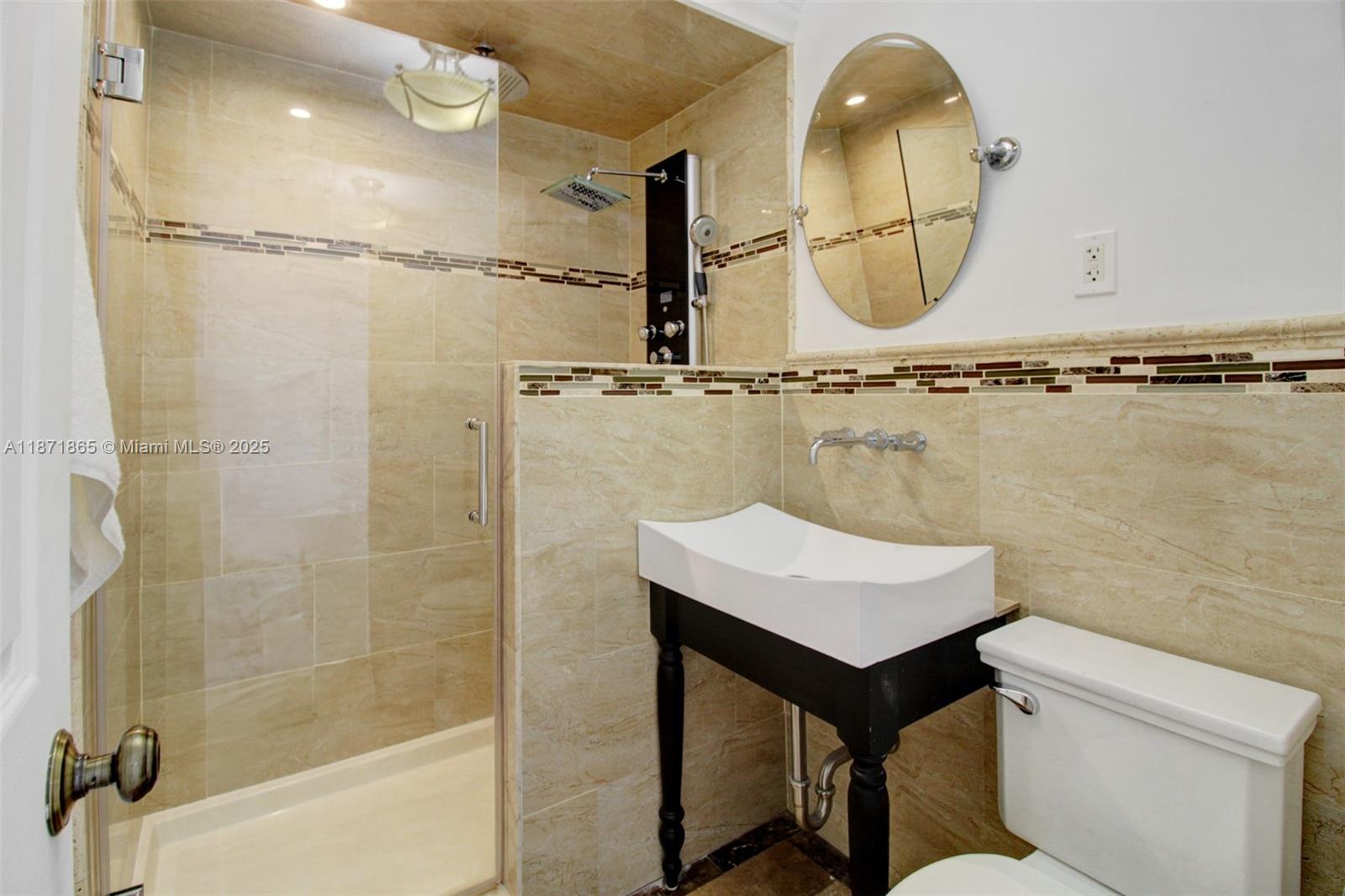 9930 Southwest 48th Street Miami, FL 33165 - Photo 15 of 29 a bathroom with a sink a mirror and a shower