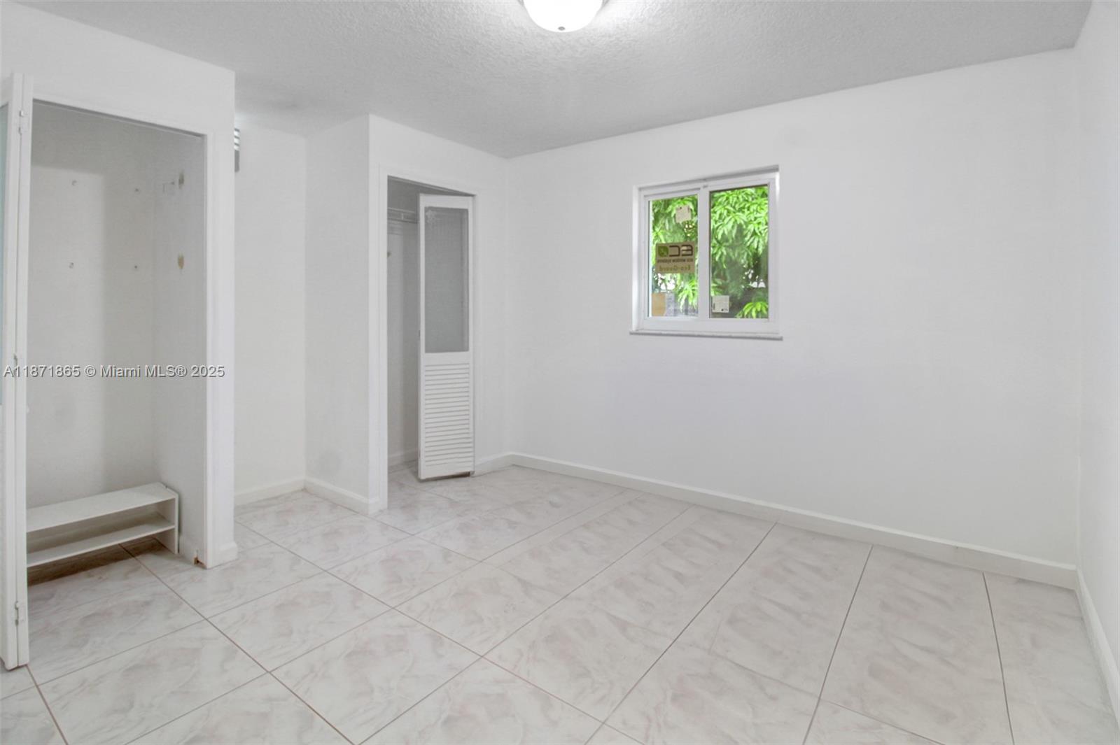 9930 Southwest 48th Street Miami, FL 33165 - Photo 17 of 29 an empty room with windows