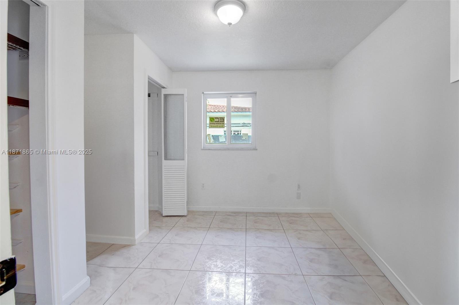 9930 Southwest 48th Street Miami, FL 33165 - Photo 19 of 29 an empty room with windows