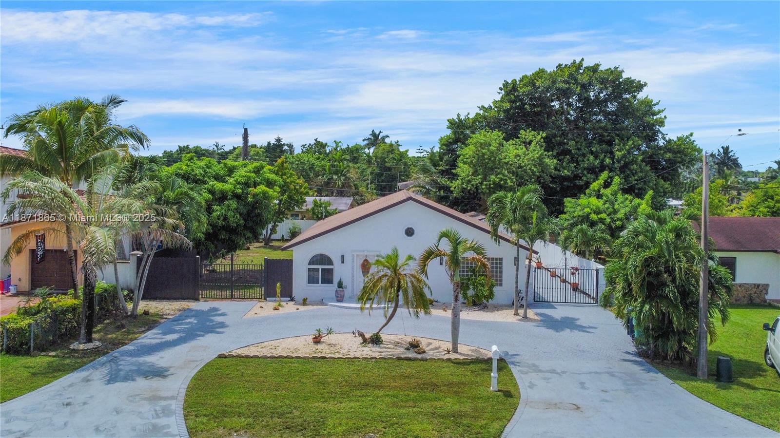9930 Southwest 48th Street Miami, FL 33165 - Photo 2 of 29 a front view of a house with garden