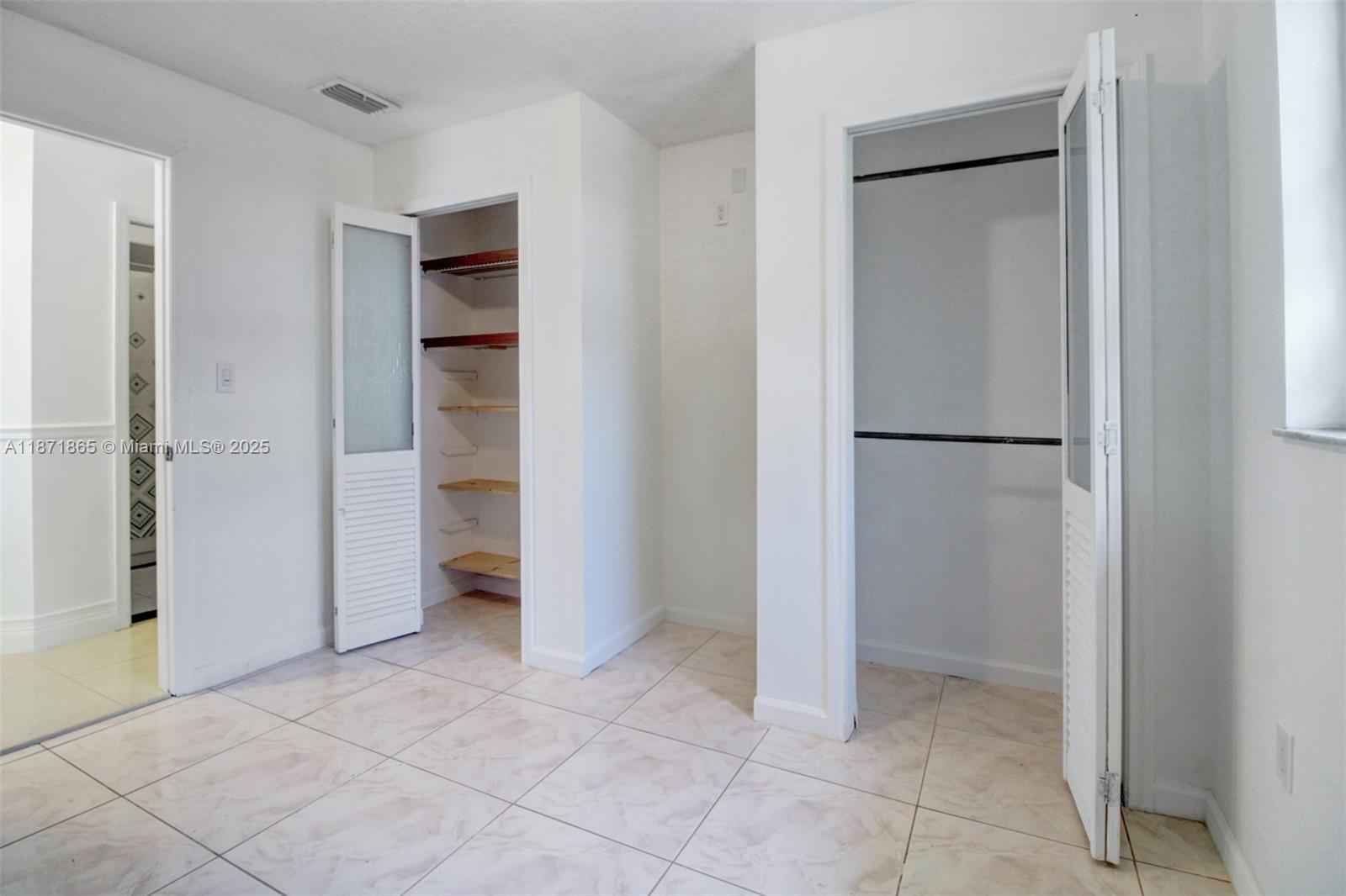 9930 Southwest 48th Street Miami, FL 33165 - Photo 21 of 29 a view of an empty room with closet and a bathroom