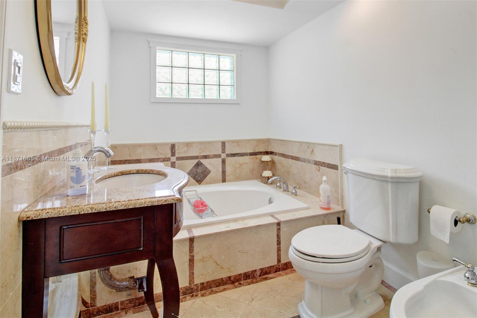 9930 Southwest 48th Street Miami, FL 33165 - Photo 24 of 29 a bathroom with a toilet a sink and a mirror