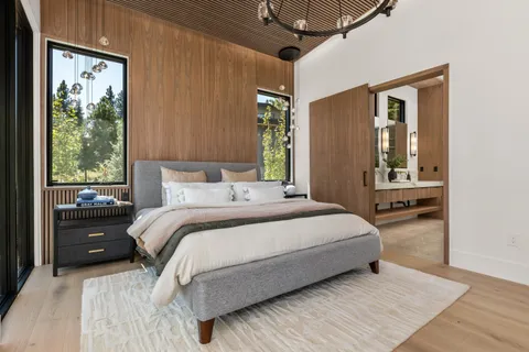 a bedroom with a bed window and a ceiling fan