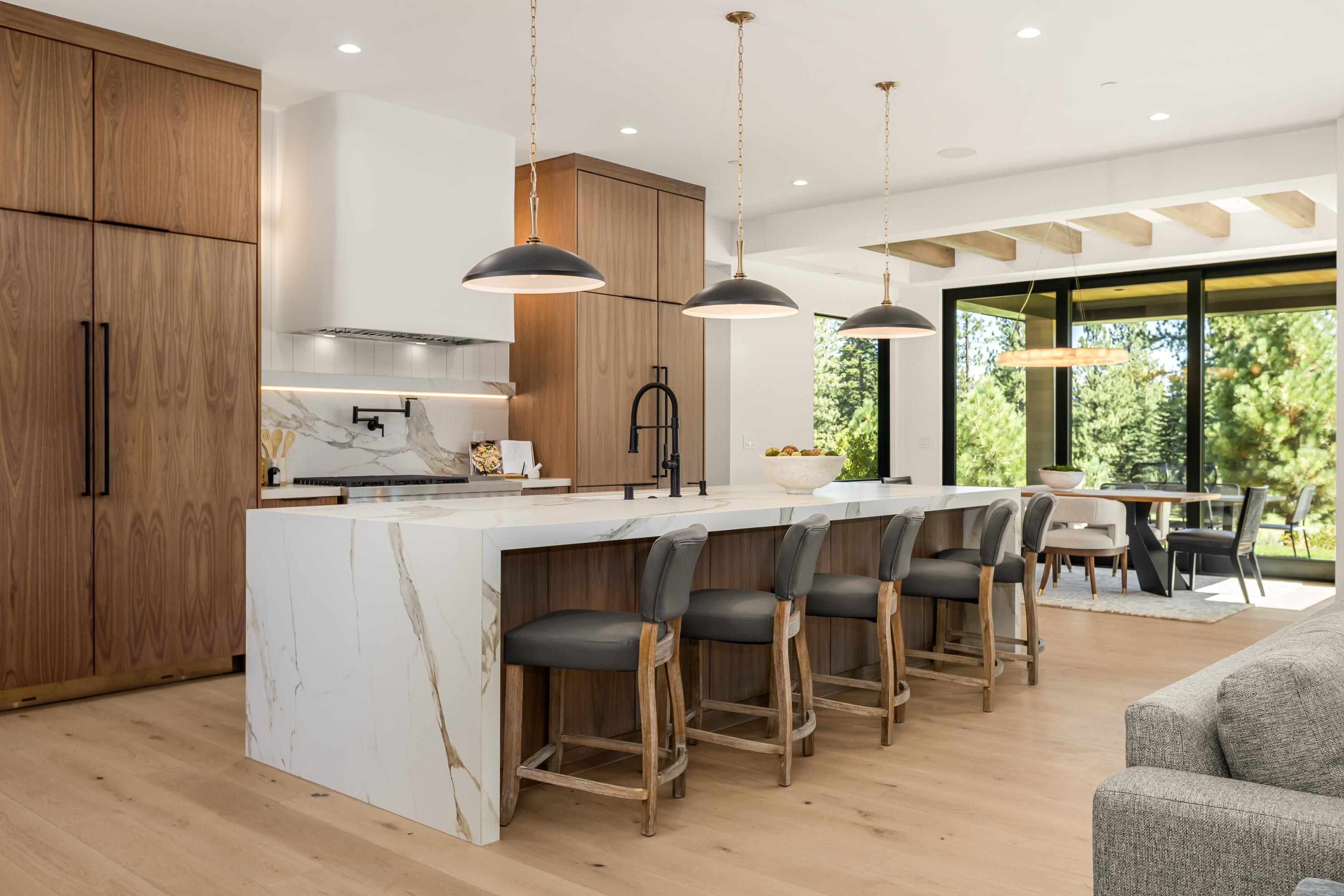 9308 Gaston Court Truckee, CA 96161 - Photo 8 of 28 a kitchen with kitchen island granite countertop a table chairs sink and wooden floor