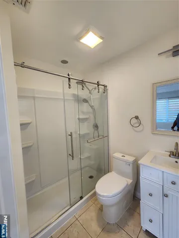 a bathroom with a toilet a sink and shower