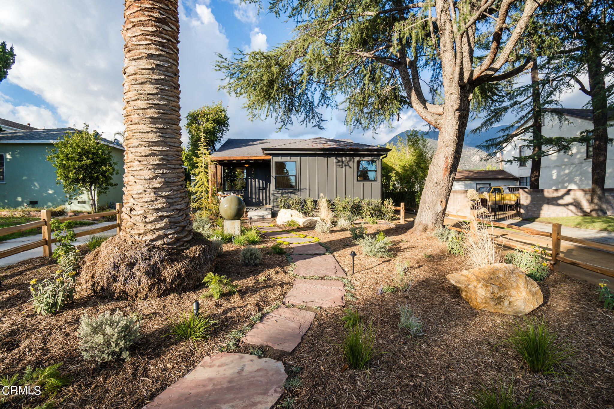 a backyard of a house with yard and outdoor seating