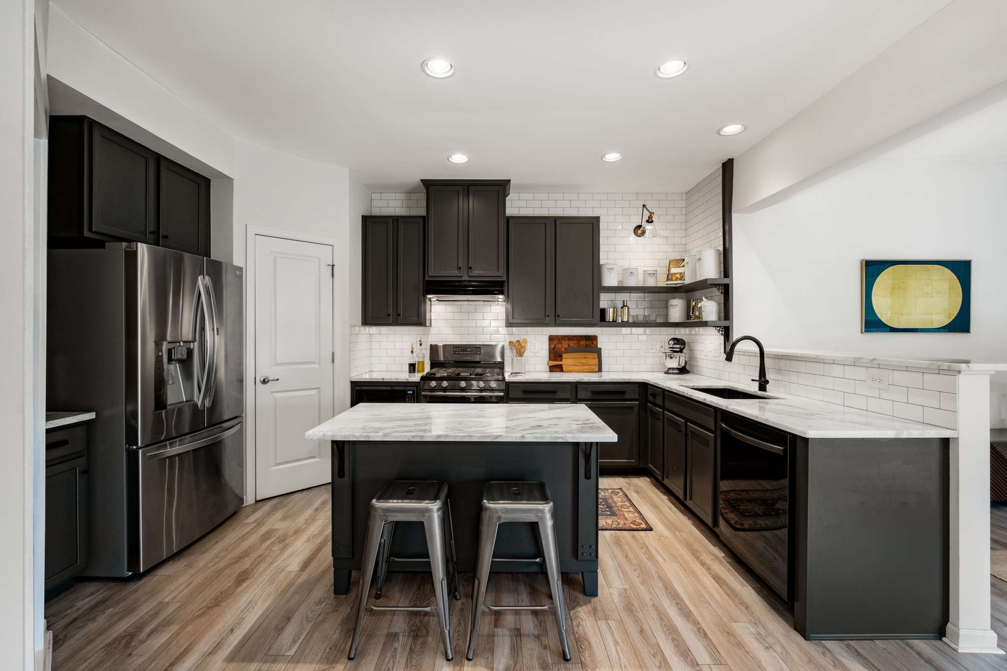 2000 Kingston Place Spring Hill, TN 37174 - Photo 8 of 56 a kitchen with stainless steel appliances a sink a stove a refrigerator cabinets and a dining table