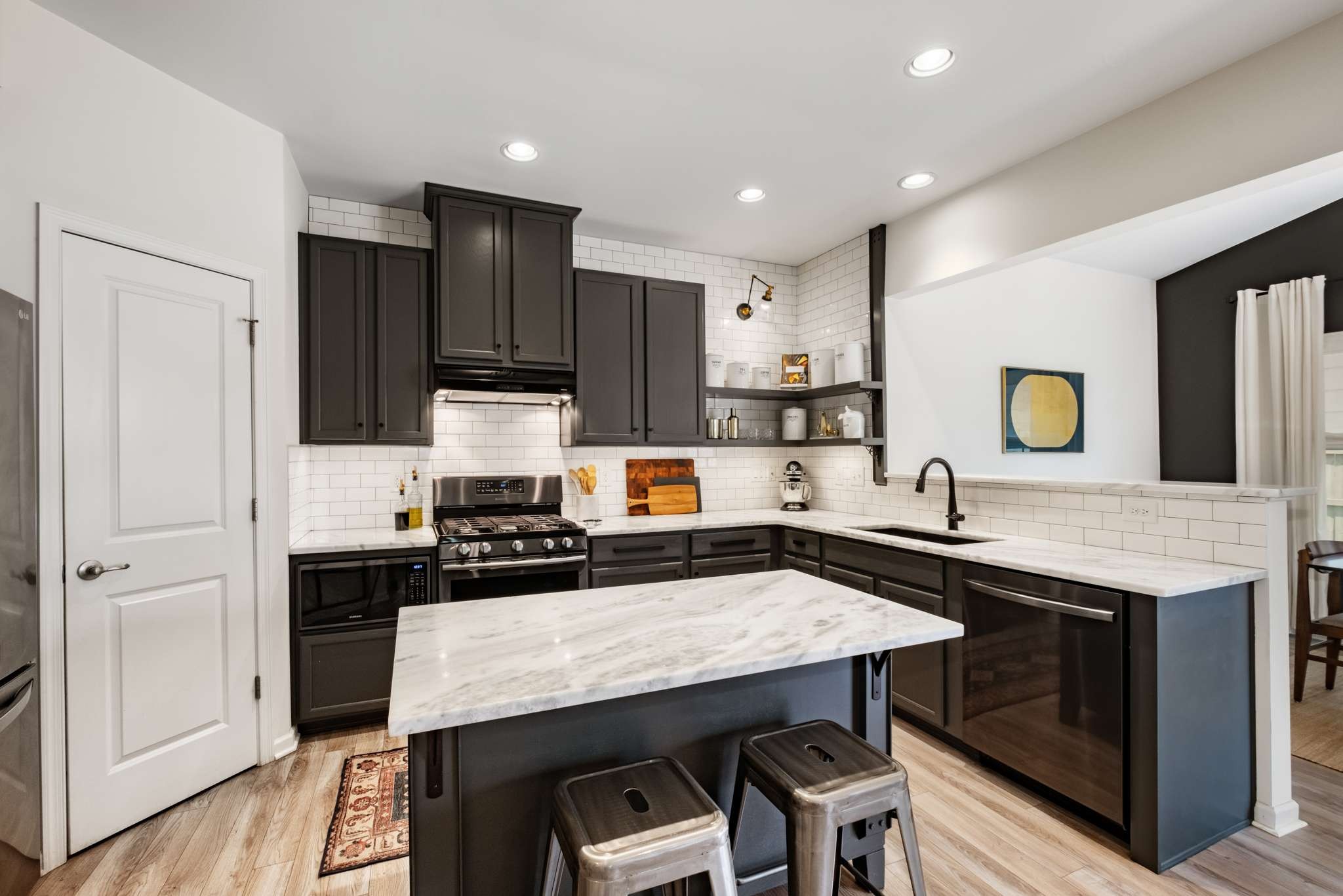 2000 Kingston Place Spring Hill, TN 37174 - Photo 9 of 56 a kitchen with kitchen island a sink counter and chairs