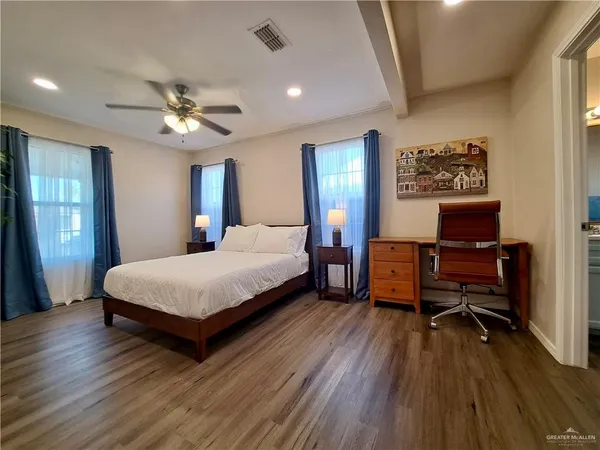 a bedroom with a bed and a desk