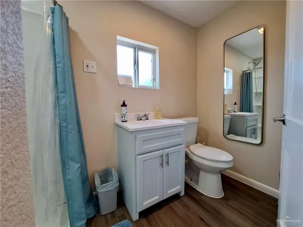 a bathroom with a sink toilet and a mirror