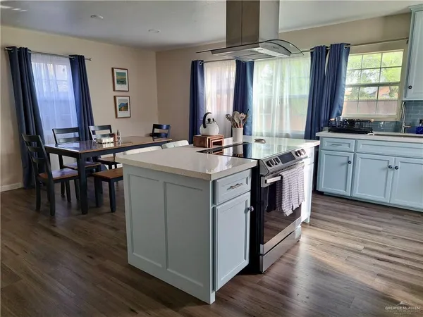 a kitchen with stainless steel appliances granite countertop wooden floors and sink