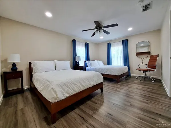 a bedroom with bed and a chandelier