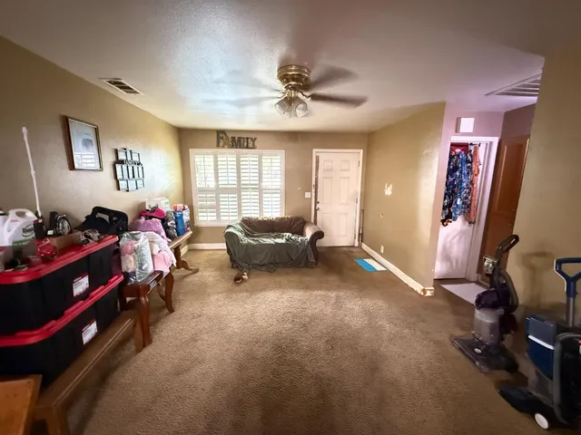 a living room with furniture a window and gym equipment