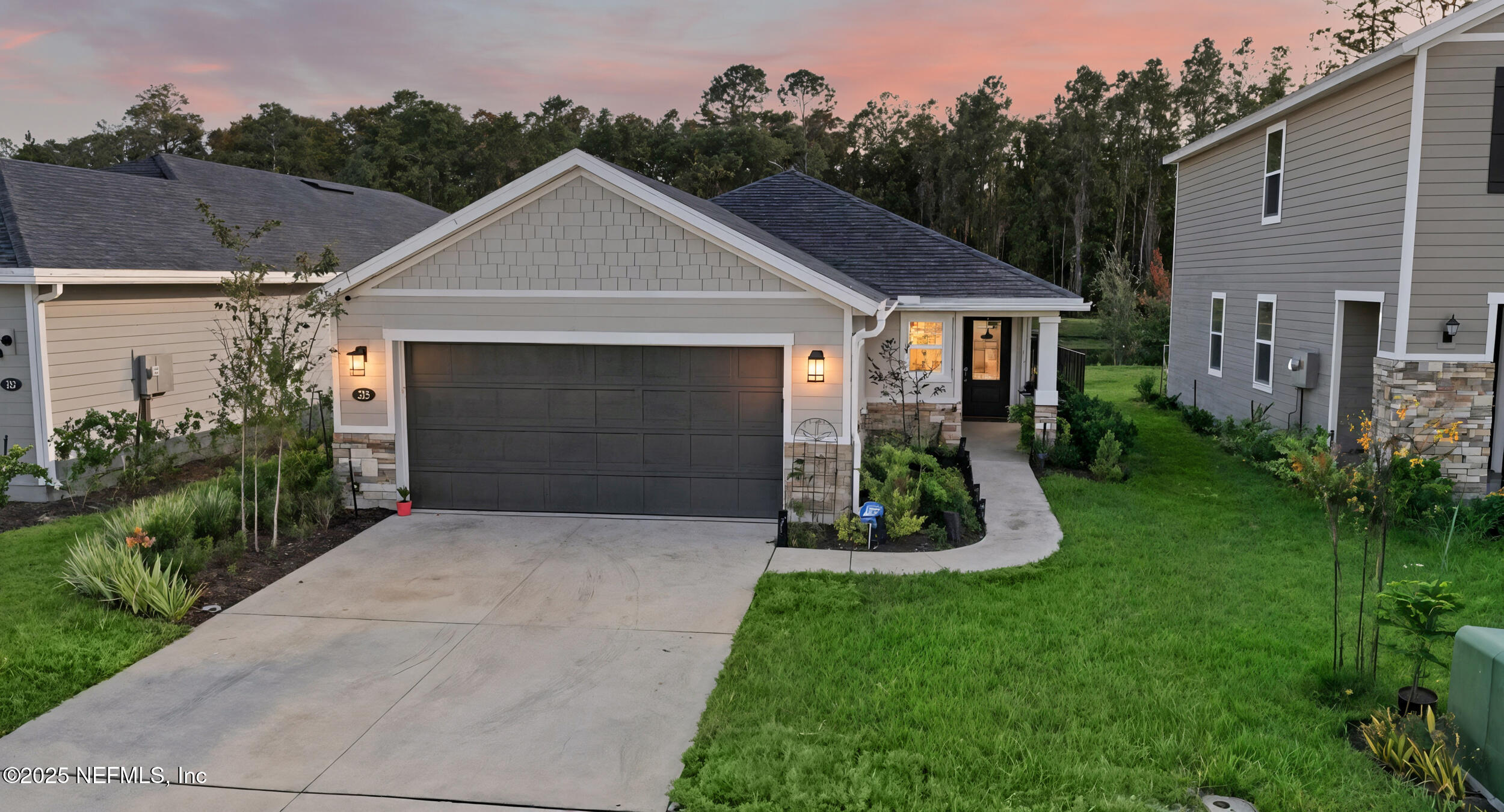 335 Boulder Lane St. Johns, FL 32259 - Photo 1 of 32 a front view of house with garden