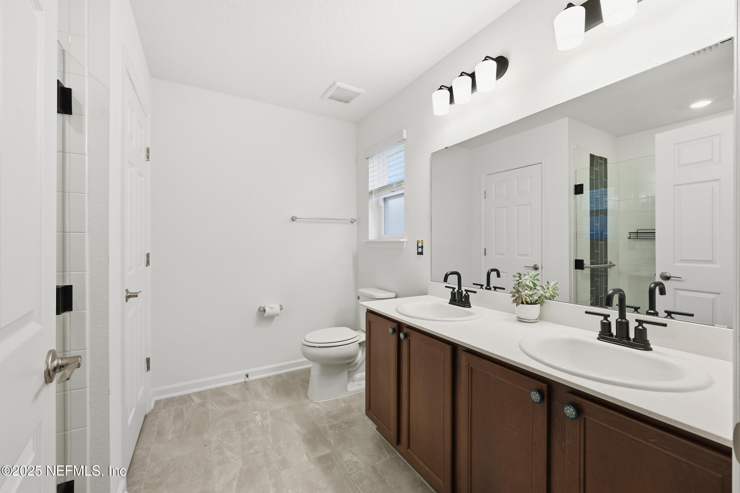 335 Boulder Lane St. Johns, FL 32259 - Photo 16 of 32 a bathroom with a sink and a mirror