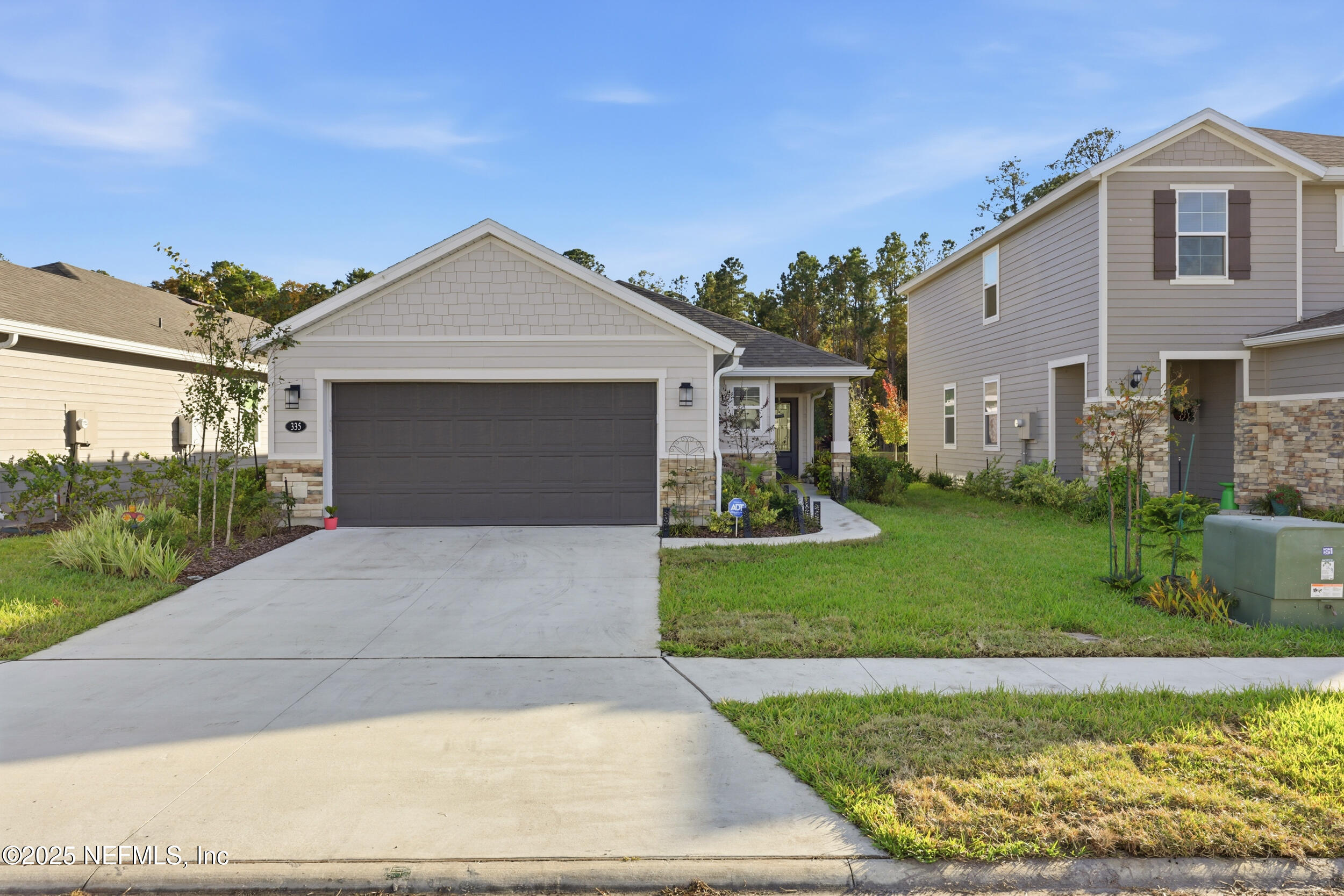 335 Boulder Lane St. Johns, FL 32259 - Photo 25 of 32 a front view of a house with garden