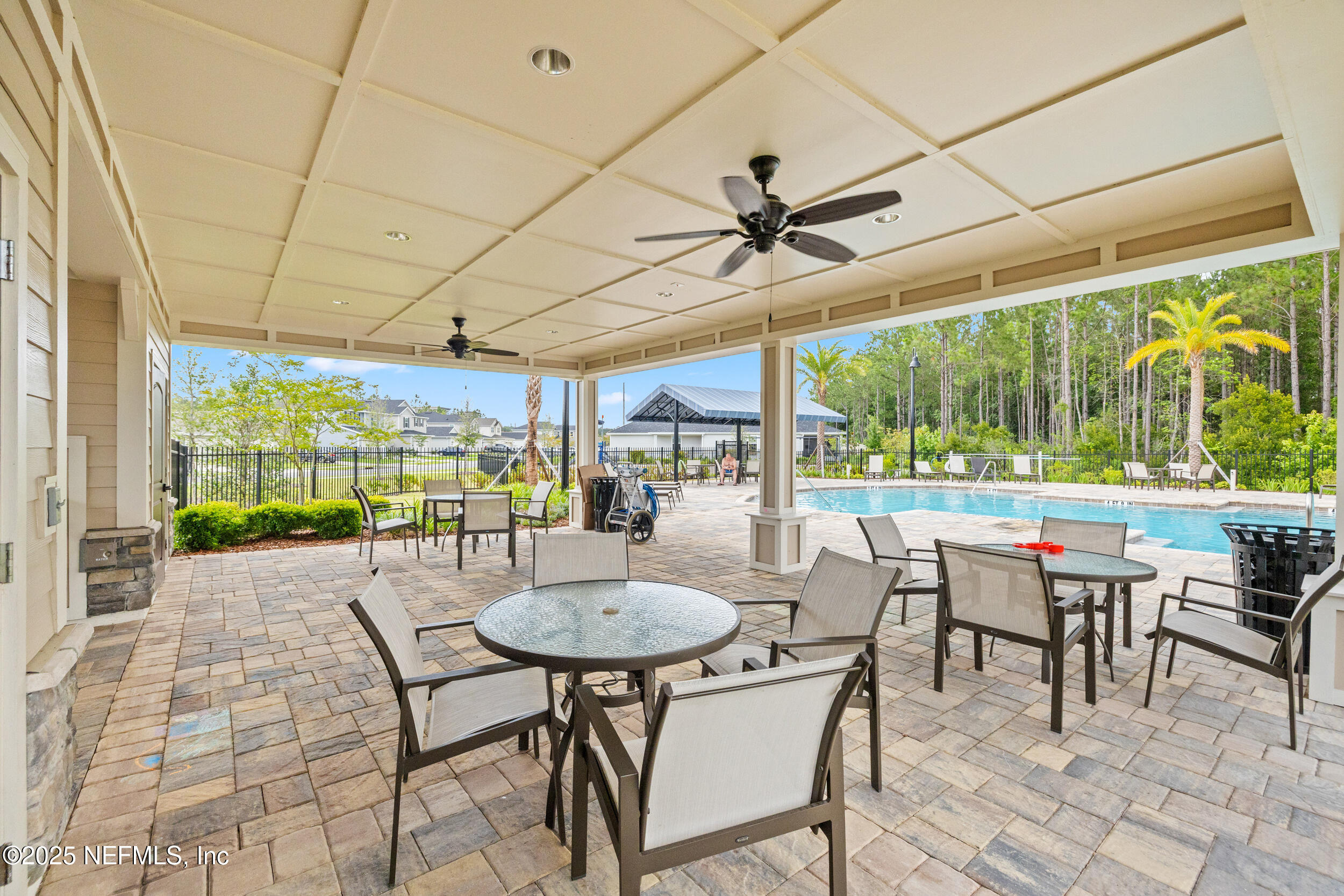 335 Boulder Lane St. Johns, FL 32259 - Photo 31 of 32 a view of a patio with a table chairs and a small yard