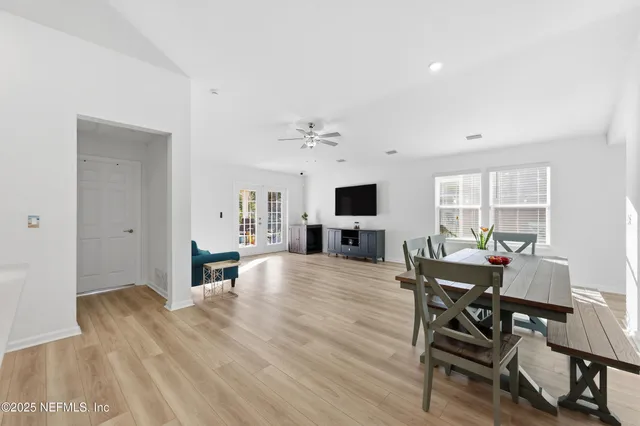 a view of a dining room with furniture and a window