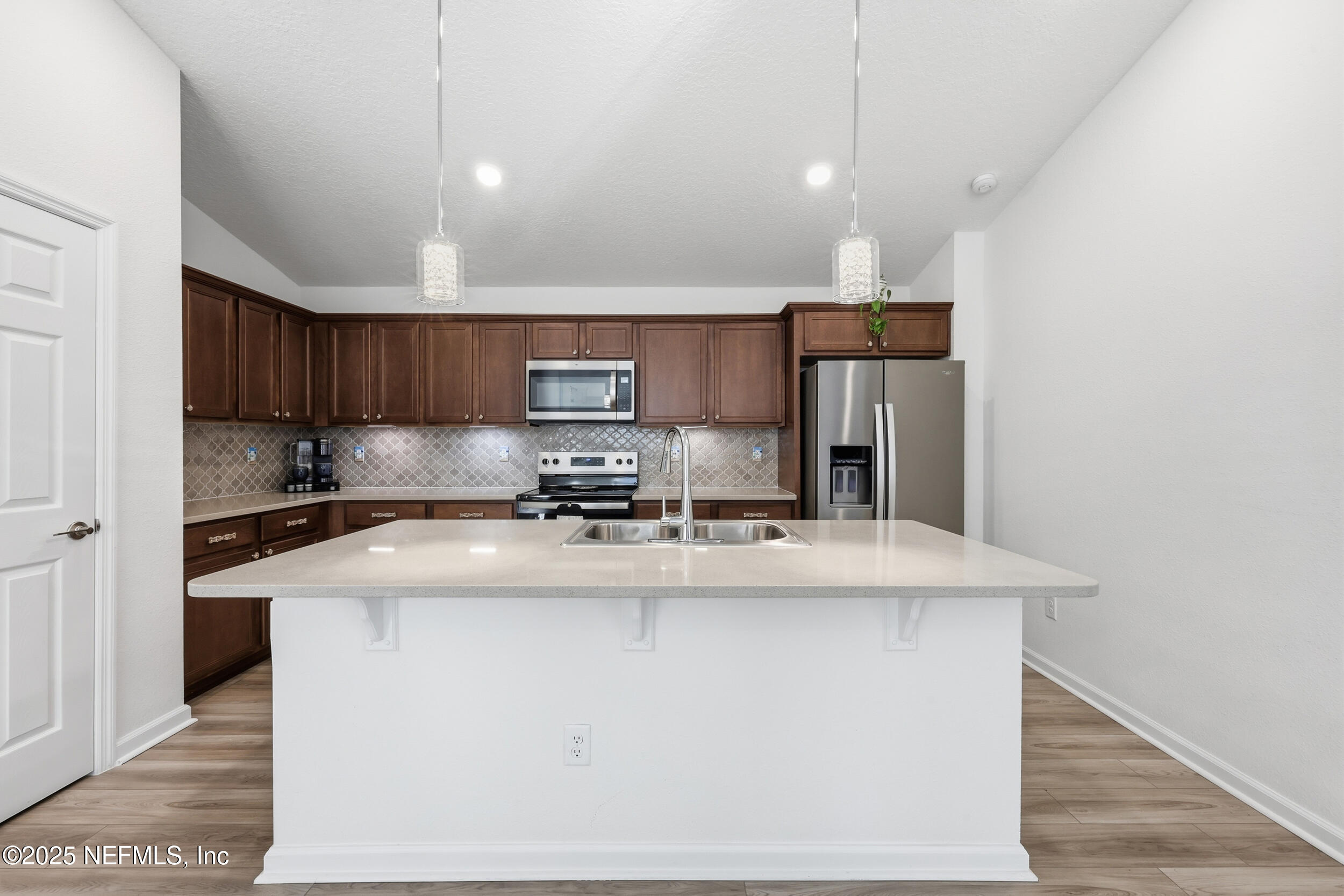 335 Boulder Lane St. Johns, FL 32259 - Photo 10 of 32 a kitchen with kitchen island a stove a sink a refrigerator and cabinets