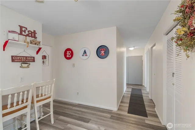 a view of an empty room with wooden floor and entryway