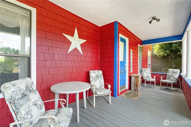 a balcony with table and chairs