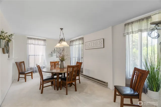 a dining room with furniture a chandelier and window