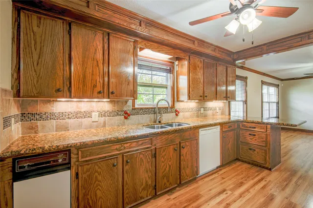 a kitchen with a sink cabinets and window