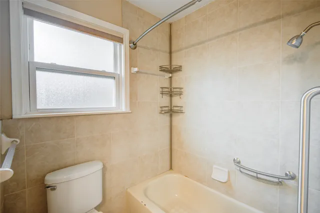 a white toilet sitting next to a bathroom sink