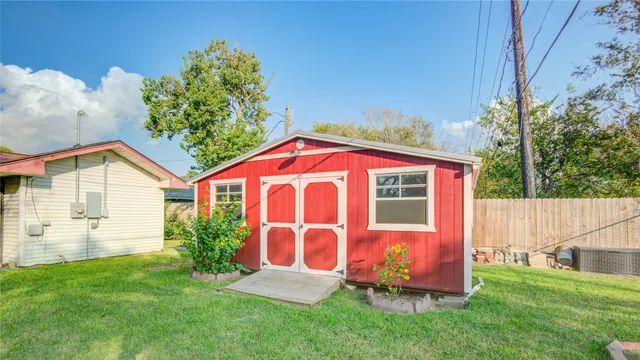 a view of backyard with garden and deck
