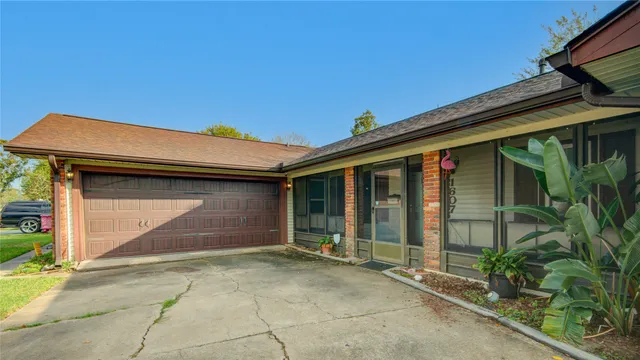 a backyard of a house with potted plants and floor to ceiling window