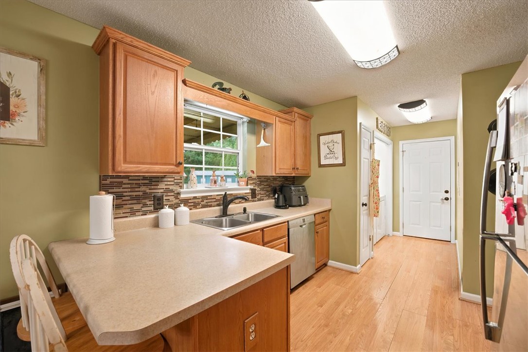 520 Sharon Lane Seneca, SC 29678 - Photo 13 of 48 A well-equipped kitchen provides abundant counter space and ample natural light from the oversized window.