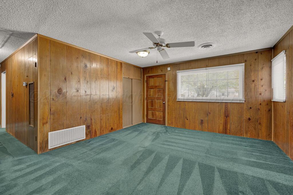 5025 South Crockett Street Amarillo, TX 79110 - Photo 11 of 30 a view of empty room with wooden floor and fan