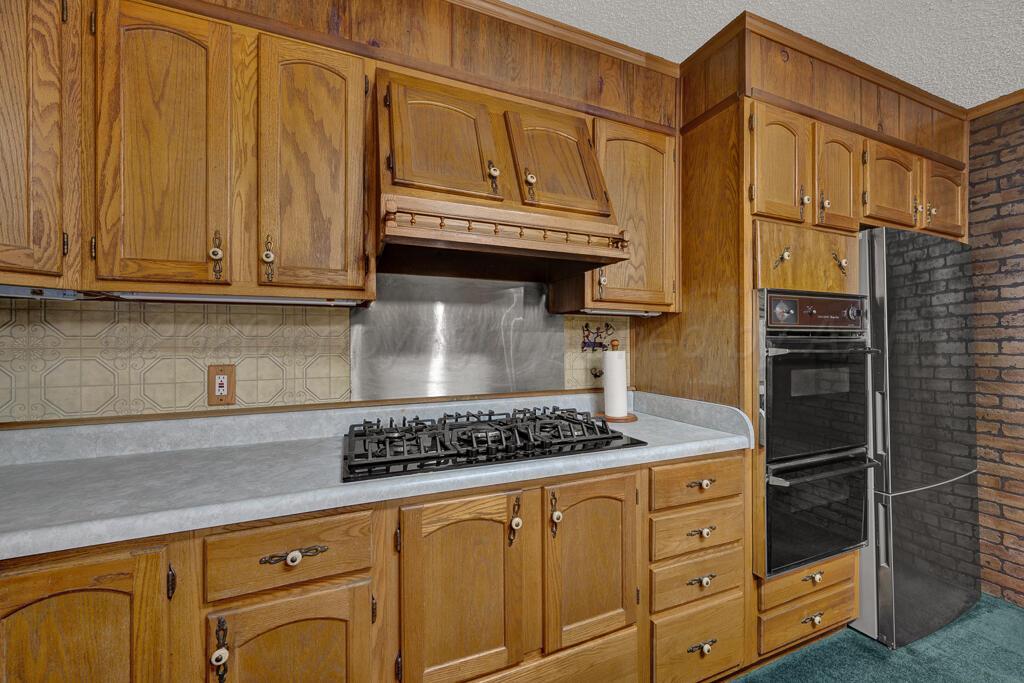 5025 South Crockett Street Amarillo, TX 79110 - Photo 13 of 30 a kitchen with stainless steel appliances a stove and a refrigerator