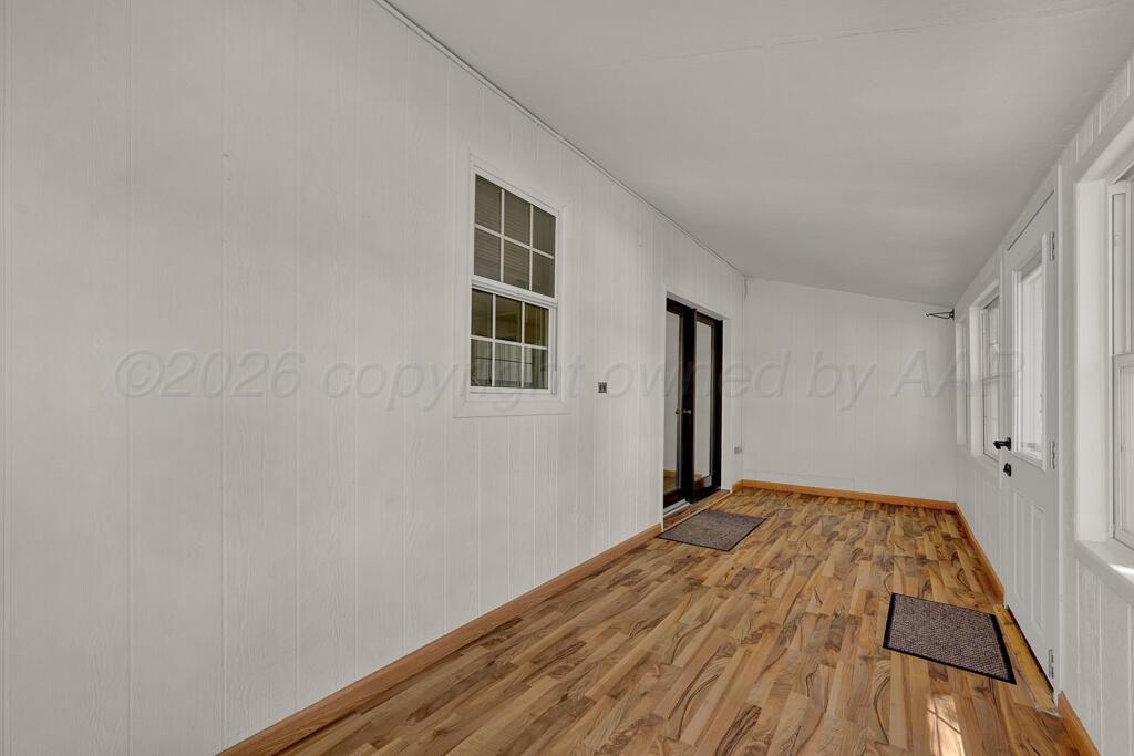 5025 South Crockett Street Amarillo, TX 79110 - Photo 16 of 30 a view of a livingroom with wooden floor and a window
