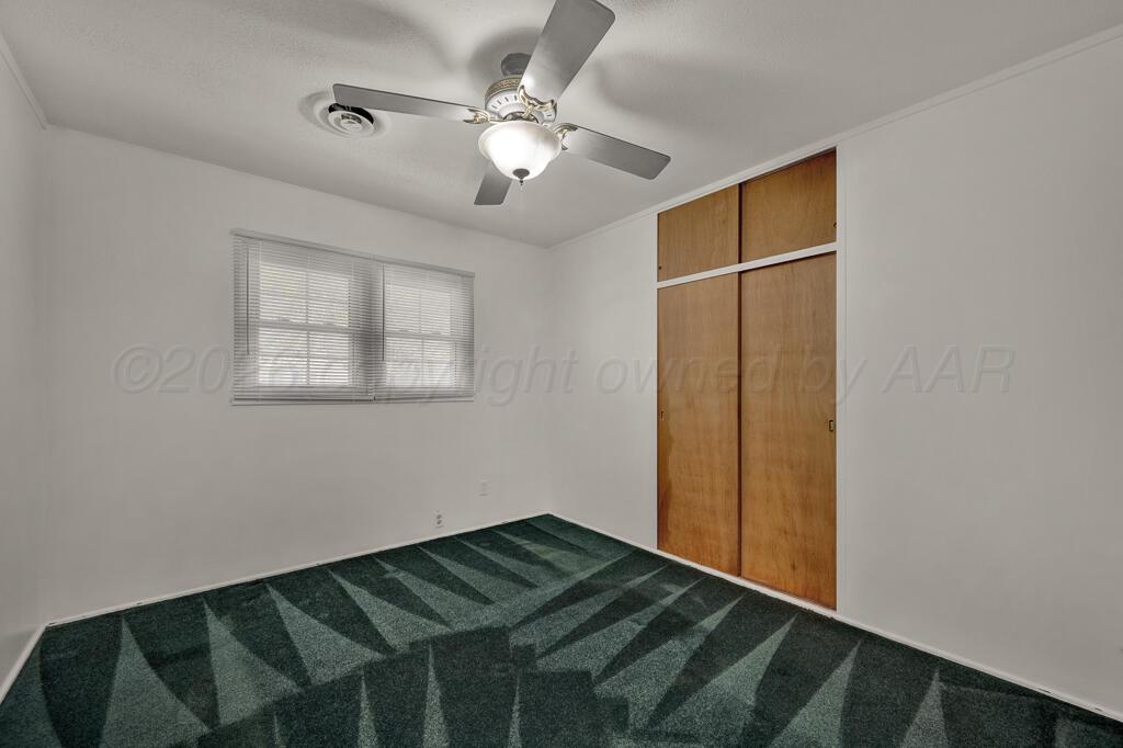 5025 South Crockett Street Amarillo, TX 79110 - Photo 17 of 30 a view of a room with wooden floor and fan