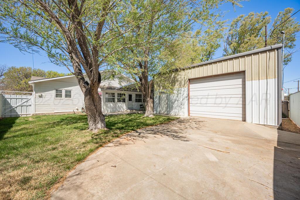 5025 South Crockett Street Amarillo, TX 79110 - Photo 2 of 30 a view of a house with a tree in the background