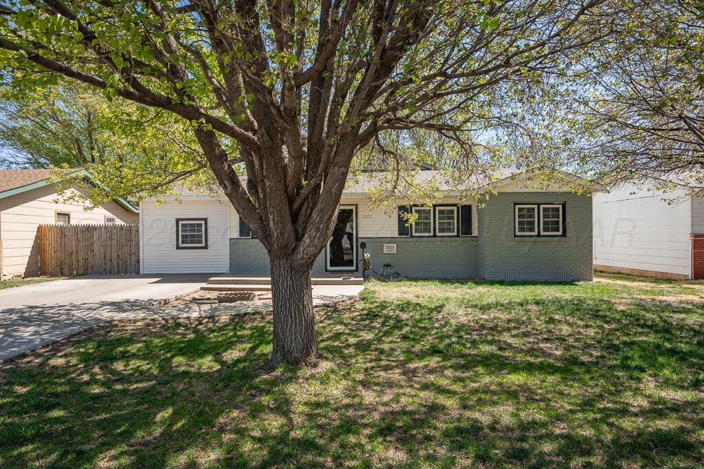 5025 South Crockett Street Amarillo, TX 79110 - Photo 30 of 30 a house with trees in front of it