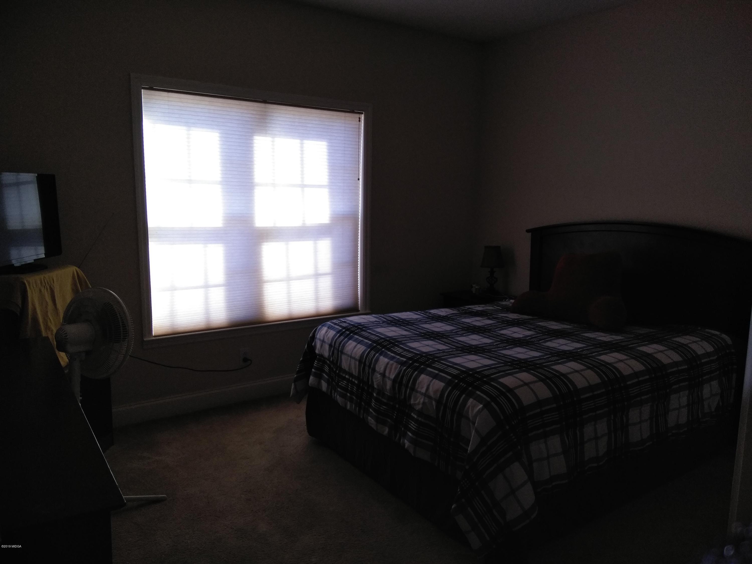 304 Browning Pointe Road Macon, GA 31216 - Photo 11 of 15 a bedroom with a bed next to a window
