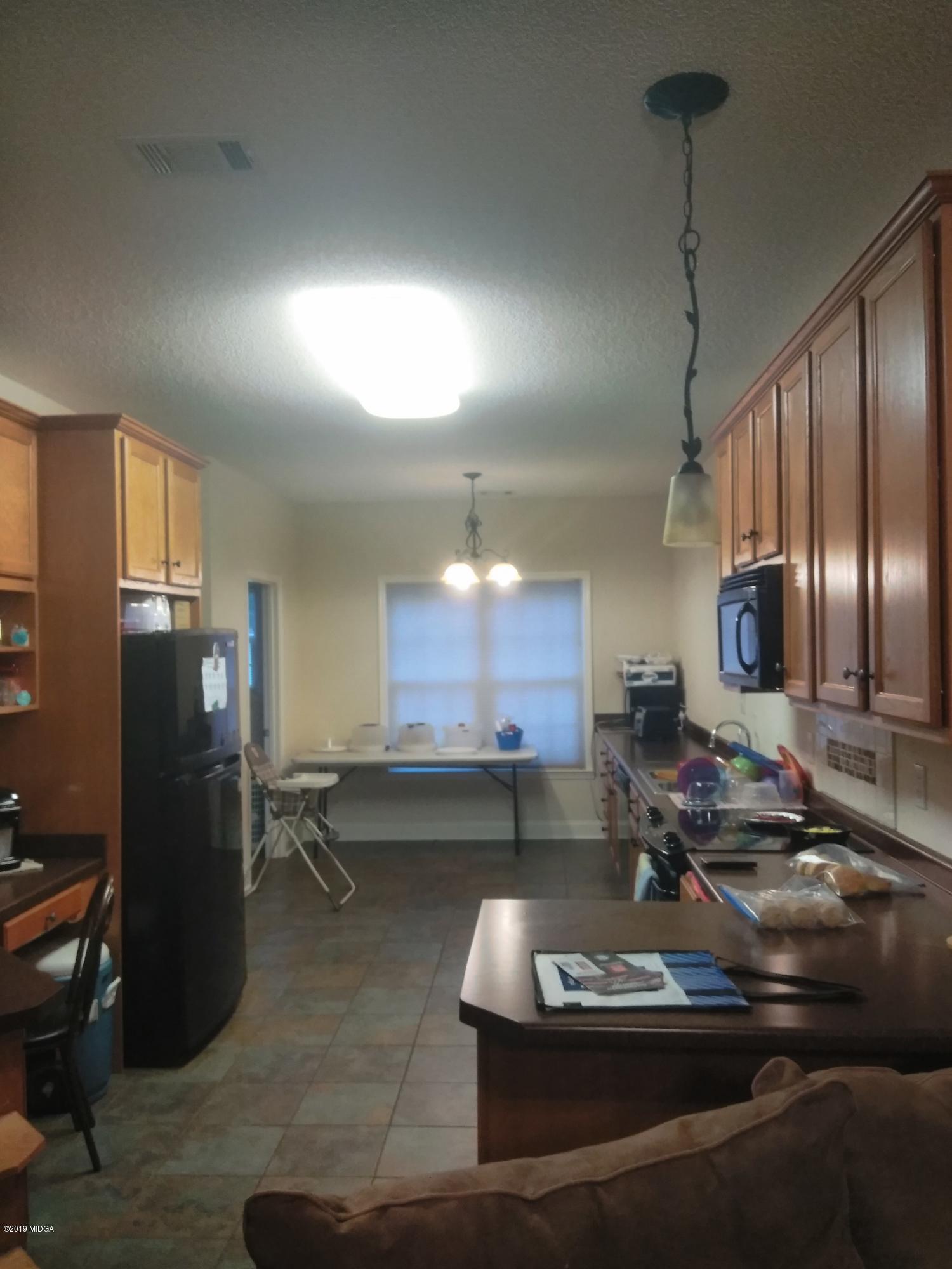304 Browning Pointe Road Macon, GA 31216 - Photo 7 of 15 a room with lots of chairs and mirrors