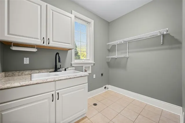 a room with a sink and cabinets