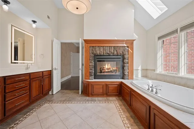 a spacious bedroom with a bed and a fireplace