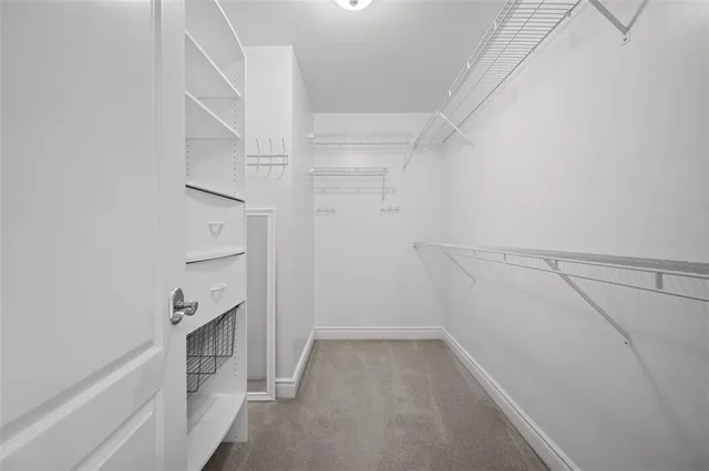 a view of walk in closet with empty racks