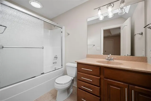 a bathroom with a sink a toilet a mirror and shower
