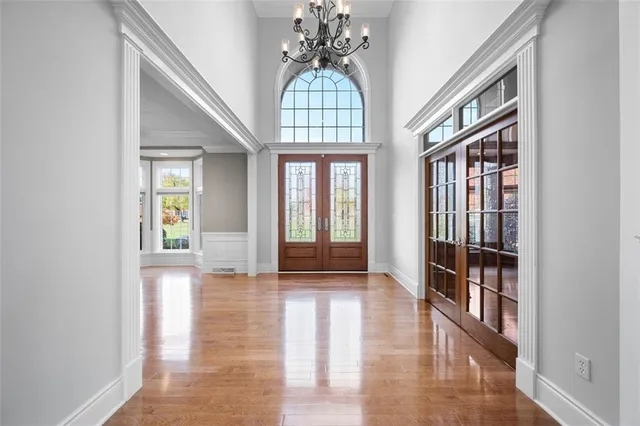 a view of an entryway with wooden floor and a chandelier