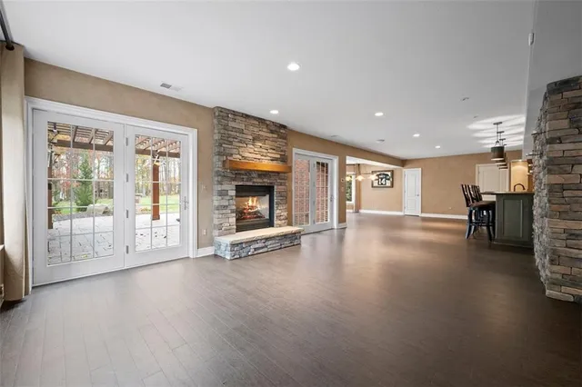 a view of empty room with wooden floor and fireplace