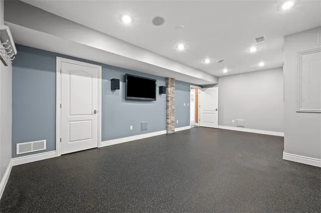 an empty room with windows and television