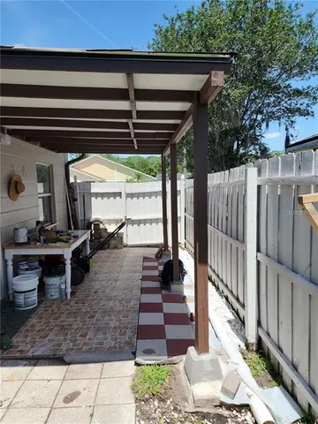 a view of a porch with wooden floor and outdoor seating