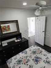 a bedroom with a bed and a dresser